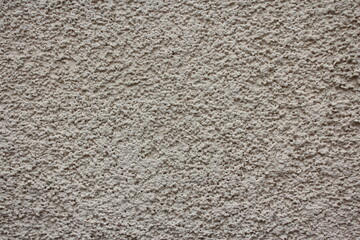Plastered beige porous wall. The texture of the industrial background.