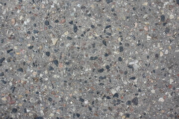 Asphalt road with small stones in close-up.