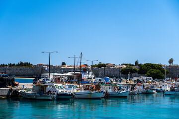 Fototapeta na wymiar 12.04.2022 fishing boats in Kolona Harbor, the second biggest commercial harbor on the island in Rhodes Greece.