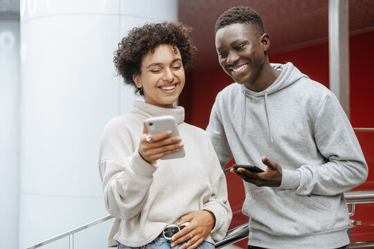 multicultural couple talking on a smartphone via video link . - Powered by Adobe