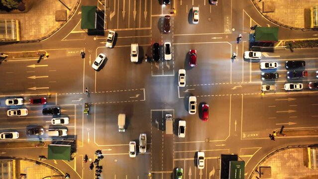 aerial view of traffic on city road intersection in midtown of jinhua at night
