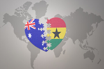 puzzle heart with the national flag of ghana and australia on a world map background. Concept.