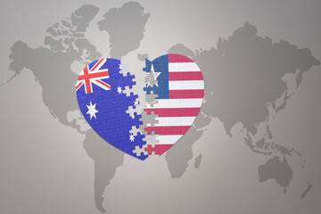 puzzle heart with the national flag of liberia and australia on a world map background. Concept.