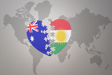 puzzle heart with the national flag of kurdistan and australia on a world map background. Concept.