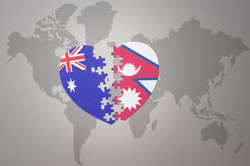 puzzle heart with the national flag of nepal and australia on a world map background. Concept.