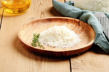 Italian minced ricotta salted cheese - ricotta salata on rustic wooden background. 