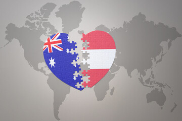 puzzle heart with the national flag of austria and australia on a world map background. Concept.