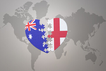 puzzle heart with the national flag of england and australia on a world map background. Concept.