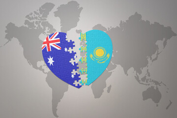 puzzle heart with the national flag of kazakhstan and australia on a world map background. Concept.