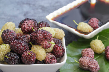 Domestic fresh mulberry molasses on a rustic wooden board
