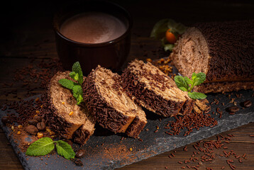 Chocolate biscuit in the form of a log, cut into portions, sprinkled with chocolate chips,...