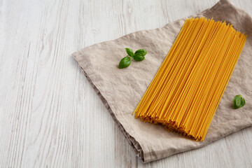 Raw Organic Spaghetti Pasta in a Bunch, side view. Copy space.
