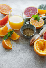 Glass of juice and citrus fruits.
