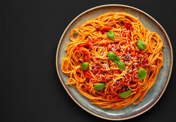 Homemade Spaghetti with Olives and Tomato Sauce on a Plate, top view. Flat lay, overhead, from above. Copy space.