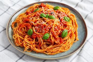 Homemade Spaghetti with Olives and Tomato Sauce, side view. Close-up.