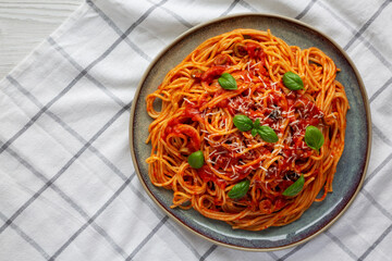 Homemade Spaghetti with Olives and Tomato Sauce, top view. Flat lay, overhead, from above. Space for text.