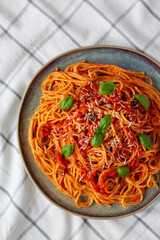 Homemade Spaghetti with Olives and Tomato Sauce, top view. Flat lay, overhead, from above.