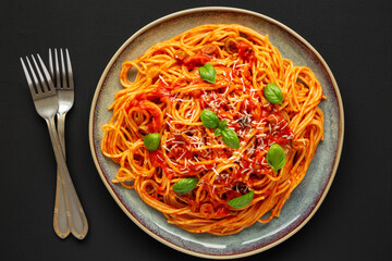 Homemade Spaghetti with Olives and Tomato Sauce on a Plate, top view. Flat lay, overhead, from above.