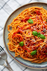 Homemade Spaghetti with Olives and Tomato Sauce on a Plate, top view. Flat lay, overhead, from above.