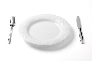 Empty plate with knife and fork isolated on a white background.