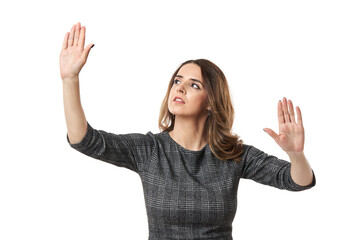 Businesswoman working an imaginary digital interface on white