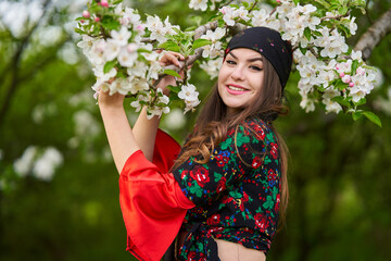 Young gypsy woman in traditional costume in an orchard