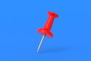 Red push pin on blue background. Stationery tools. Office equipment. School education. 3d render
