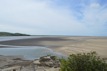 Port Meirion flat sand beach with water