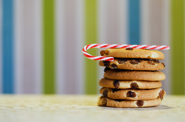 Christmas oatmeal cookies, biscuits with red ribbon against colorful background. Abstract texture. New Year morning, breakfast. Top view food.
