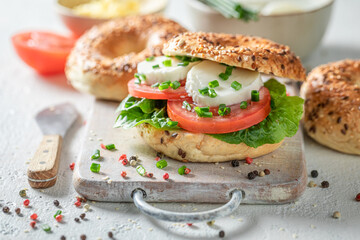 Yummy and crunchy golden bagels with tomatoes, lettuce and mozzarella.