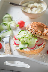Homemade and crunchy golden bagel with radish and cottage cheese.