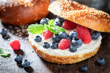 Healthy and sweet golden bagels with blueberries and raspberries.