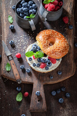 Sweet and homemade golden bagels with blueberries and raspberries.