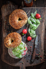 Homemade and crunchy golden bagel with cottage cheese and cucumber.