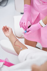 Woman lies in a medical office on a plasmolifting procedure