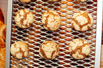 Round buns on a metal grill. Production of a small bakery on industrial equipment. flat lay frame