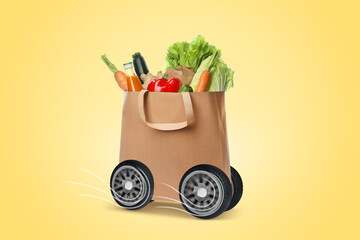 Paper shopping bag full of products on wheels against pale yellow background. Order hurrying to...