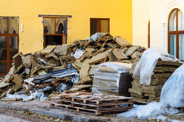 A pile of old mineral wool insulation is prepared for disposal. Replacement of thermal insulation...