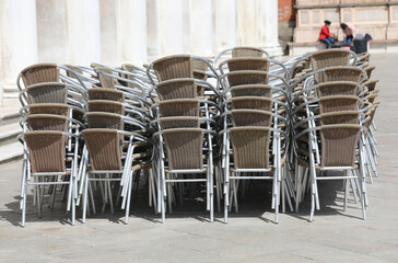chairs piled up in the closed bar during the terrible lockdown caused by the coronavirus in the...