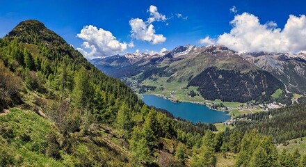 Naklejka na ściany i meble Davos highest city in Europe. Beautiful view of Lake Davos and Davos. Spring time in the mountains. mountain landscape