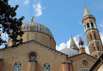Fototapeta na wymiar Bell towers and dome of the Basilica of Saint Anthony from Padua also called SANTO ANTONIO in Italian language in Padova City in Italy and the golden angel used as a weather vane