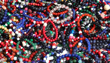 background of lots of cheesy colorful beaded bracelets and bangles for sale in the flea market stall