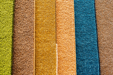 Samples of carpets of different colors with a small pile. Trade in floor coverings in the...