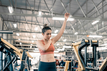 Woman has injury and hurt at arms while workout and weight training at gym, muscle pain concept