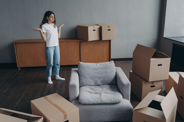 Spanish woman feels hard to move alone exhausted with boxes packing. Delivery service ordering.
