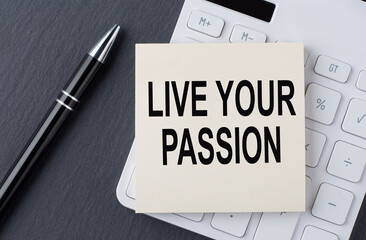 Text LIVE YOUR PASSION on the sticker on the calculator, business concept
