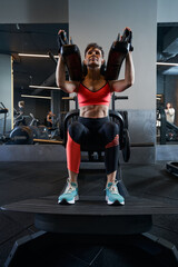 Fototapeta na wymiar Sporty woman performing leg exercise at gym