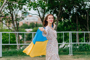 Ukrainian woman with the flag of Ukraine. Patriotic photo. Blue and yellow flag of Ukraine. Girl with the flag of Ukraine