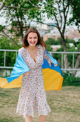 Ukrainian woman with the flag of Ukraine. Patriotic photo. Blue and yellow flag of Ukraine. Girl with the flag of Ukraine