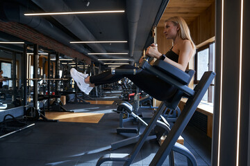 Athletic woman doing strength training in fitness club